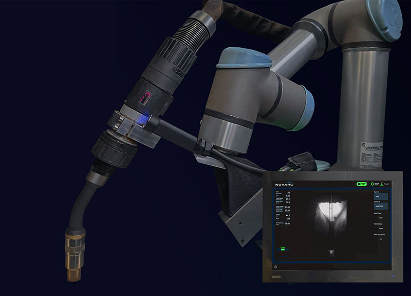 A robotic welding arm with a nozzle is positioned near a metal piece. A screen on the side displays welding parameters and a video feed of the process, all set against a dark background.