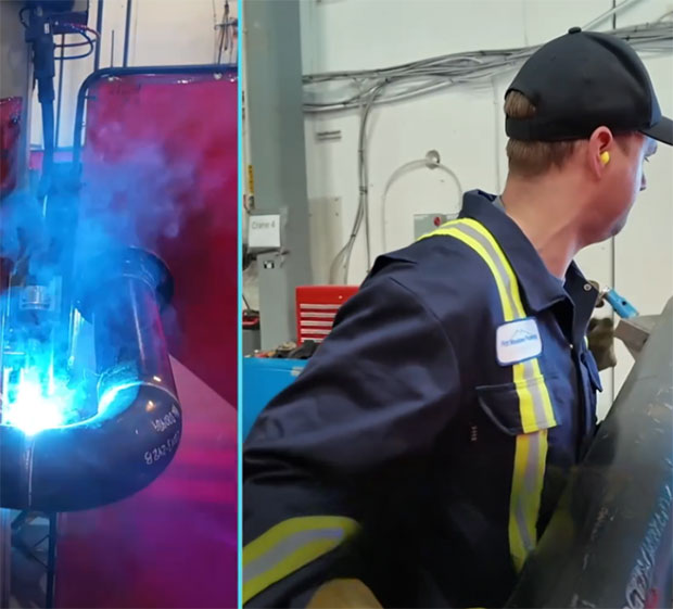 A welder in safety gear works on a pipe emitting bright blue sparks, while another worker in a dark uniform with reflective stripes carries equipment nearby.