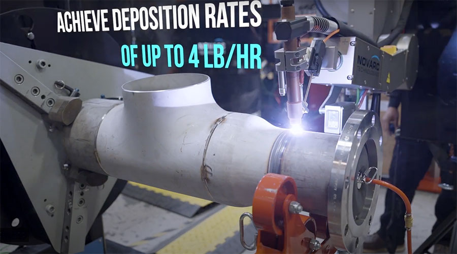 Industrial setup for metal deposition, showing robotic machinery working on a cylindrical metal pipe. Text overlay reads, "ACHIEVE DEPOSITION RATES OF UP TO 4 LB/HR.