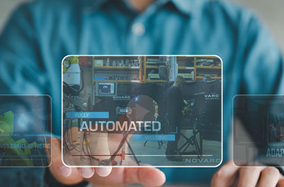 A person in a blue shirt interacts with a transparent display featuring the words "Fully Automated Welding" and images of welding equipment. The background includes additional smaller displays titled "The Future of Welding is Here" and "Novarc Adaptive Welding.